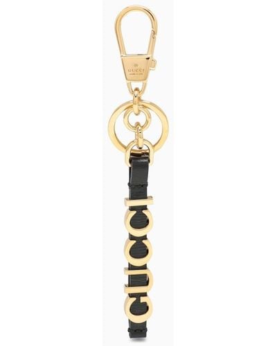 Gucci Portachiavi nero e oro in pelle con logo - Metallizzato