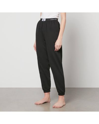 Buy Calvin Klein Jeans Women Beige Solid Relaxed Fit Joggers With Printed  Sides - Track Pants for Women 19008264 | Myntra