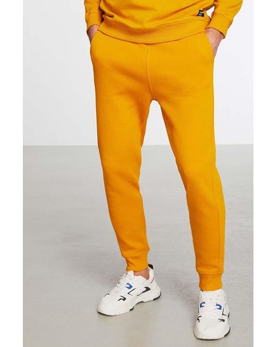 Grimelange Jeremiah jogginghose aus dehnbarem stoff in safran mit normalem bein, lanyard-taille und elastischen taschen - Orange