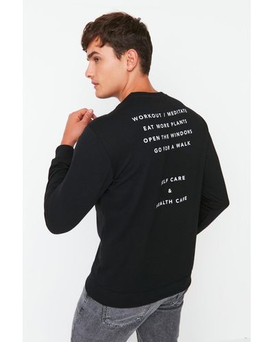 Trendyol Es sweatshirt mit normalem/normalem schnitt und langen ärmeln und rundhalsausschnitt mit textdruck - Schwarz