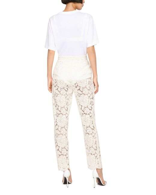 Pantalon en dentelle stretch à logo Dolce & Gabbana en coloris White
