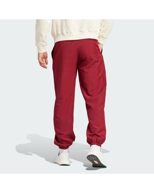 https://cdna.lystit.com/520/650/n/photos/adidas/089fb1f8/adidas-Red-Manchester-United-Lfstlr-Woven-Tracksuit-Bottoms.jpeg