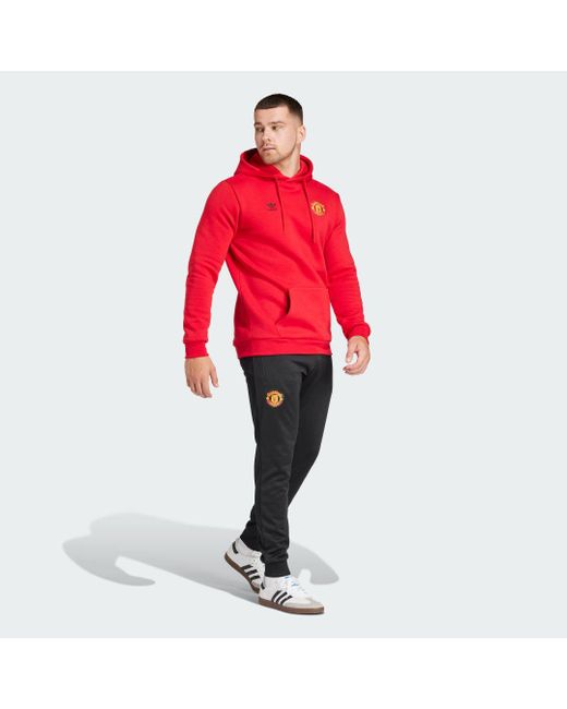 Pantaloni da allenamento Essentials Trefoil Manchester United FC di Adidas in Red da Uomo