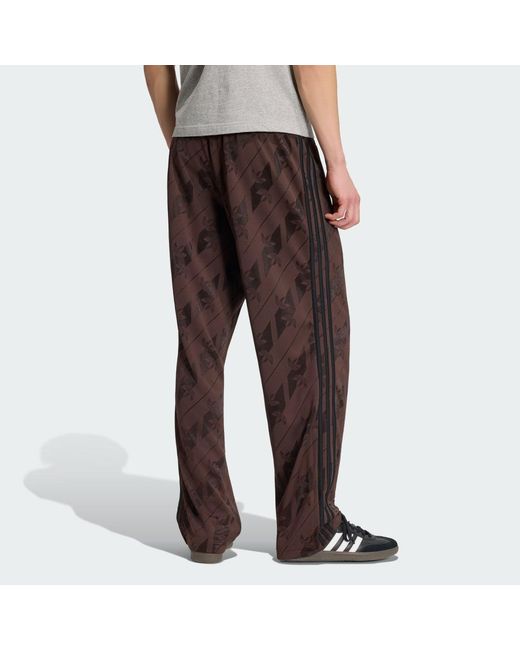 Adidas Brown Monogram Firebird Track Pants for men