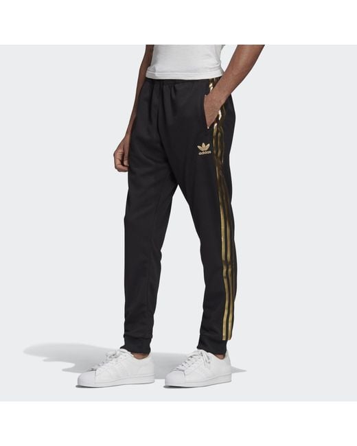 Adidas black sst track pants hotsell