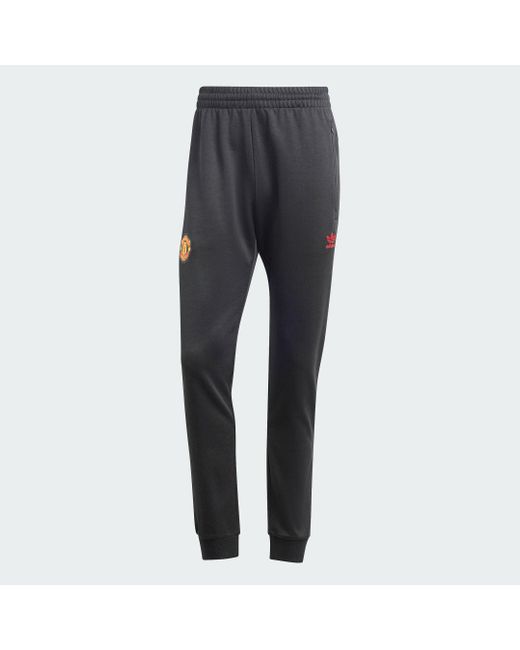 Adidas Red Manchester United Essentials Trefoil Joggers for men