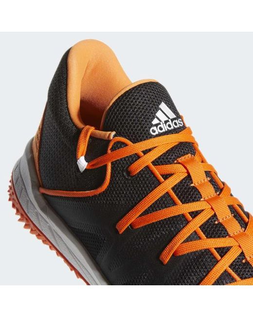 black and orange turf shoes