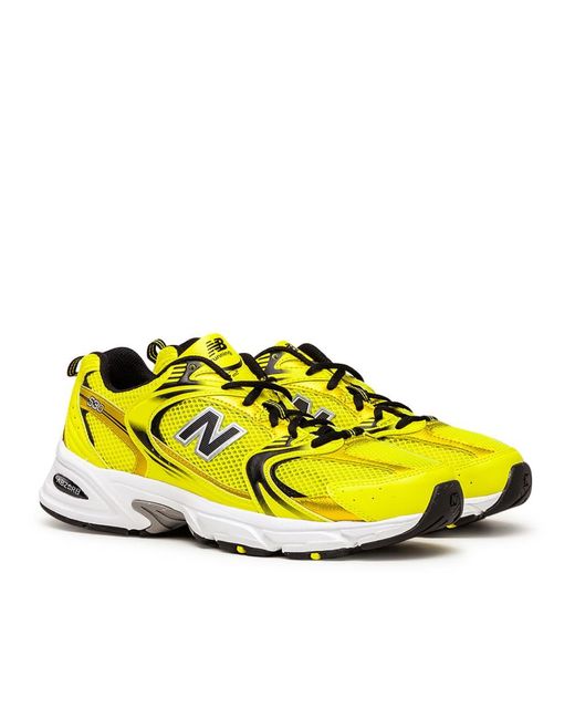new balance 530 trainers in off white and yellow