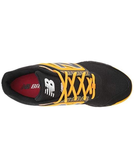 new balance black and yellow turf shoes