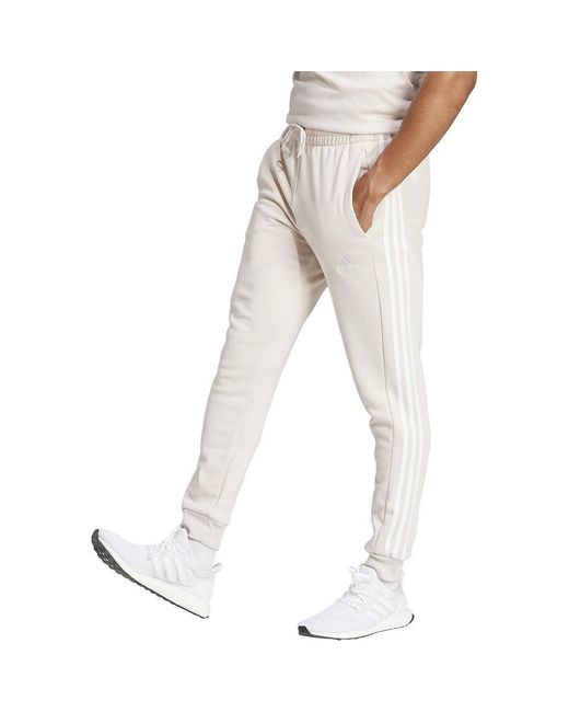 Essentials Fleece 3-Stripes Tapered Cuff Pants Pantaloni di Adidas in Natural da Uomo