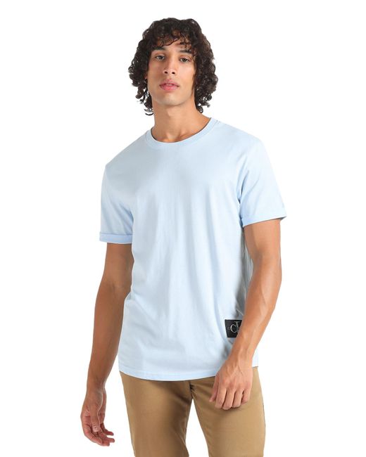 Jeans Badge Turn UP Sleeve J30J323482 di Calvin Klein in White da Uomo