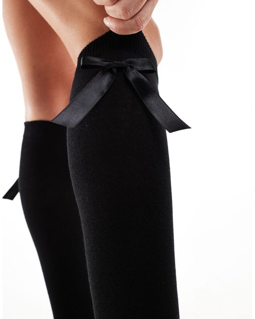Chaussettes hauteur genou avec nœud ASOS en coloris Black
