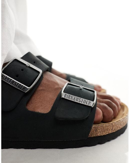 Arizona - sandales en cuir effet huilé Birkenstock en coloris Black