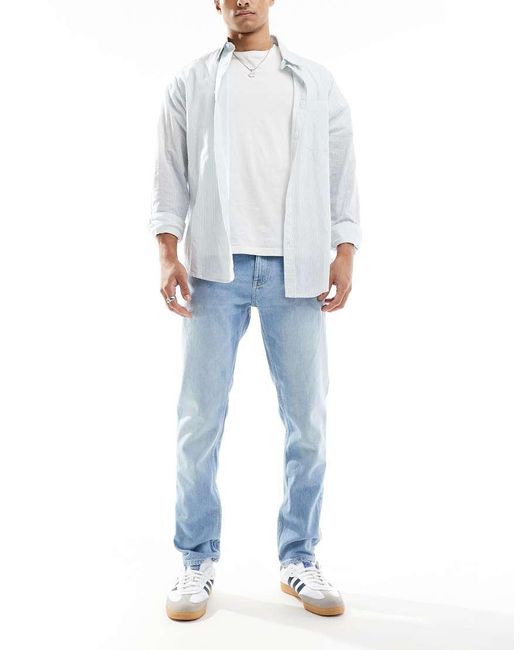 Vaqueros De Corte Tapered Slim Con Lavado Claro Austin De -Azul Tommy Hilfiger de hombre de color Blue