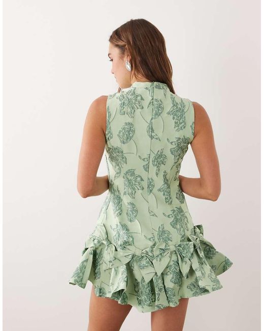 Sister Jane Green Exclusive Jacquard Sleeveless Cinched Waist Bow Hem Mini Dress