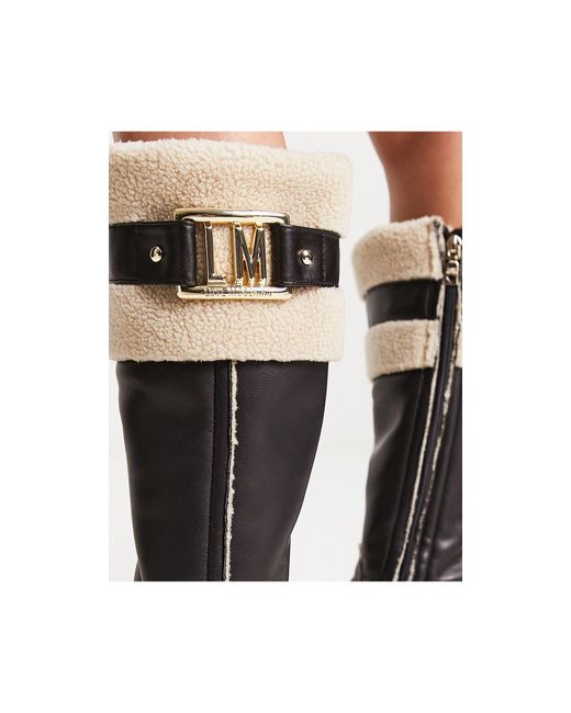 Bottes montantes avec bord en fausse fourrure - /crème Love Moschino en coloris Black