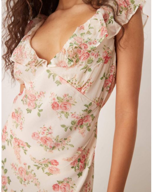 Robe longueur mollet à volants et col v - imprimé fleurs Mango en coloris Natural