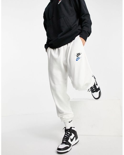 Nike Essential Fleece+ Multi Logo Casual Fit Cuffed Trackies in White for  Men | Lyst Australia