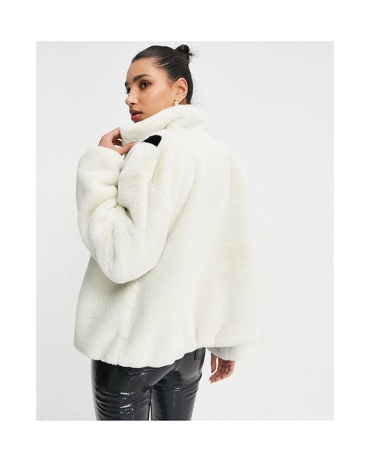 nike faux fur oversized swoosh jacket in cream