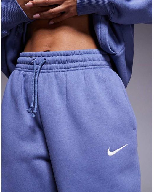 Joggers Azules Extragrandes De Talle Alto Con Bajos Ajustados Phoenix Fleece De Nike de color Blue