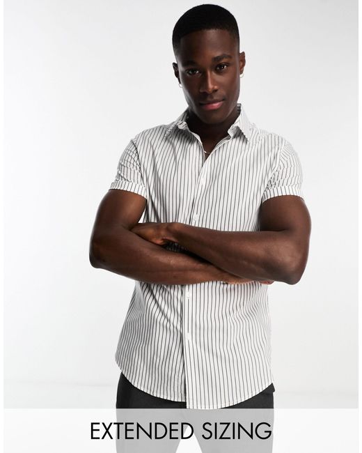 Camicia slim a maniche corte nera e bianca a righe da Uomo di ASOS in  Bianco | Lyst