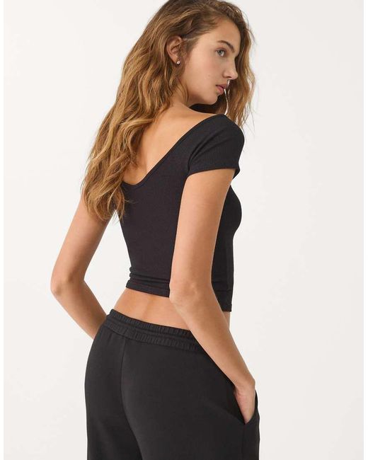 T-Shirt Nera A Coste Con Scollo A V di Stradivarius in Black