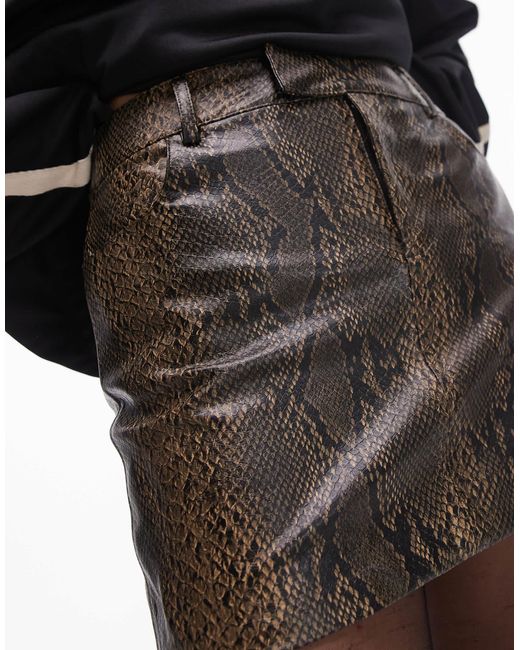 Mini-jupe en imitation cuir à imprimé serpent Mango en coloris Brown