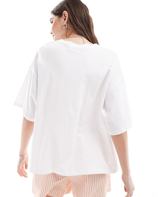 T-shirt oversize bianca con grafica "nyc" con rose di ASOS in White
