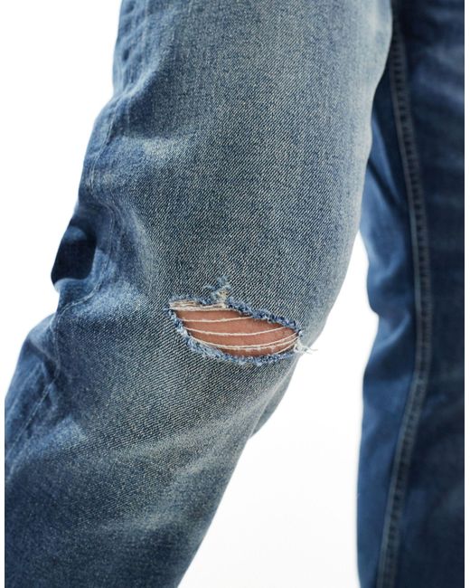 Jeans stretch slim scuro con strappi sulle ginocchia di ASOS in Blue da Uomo