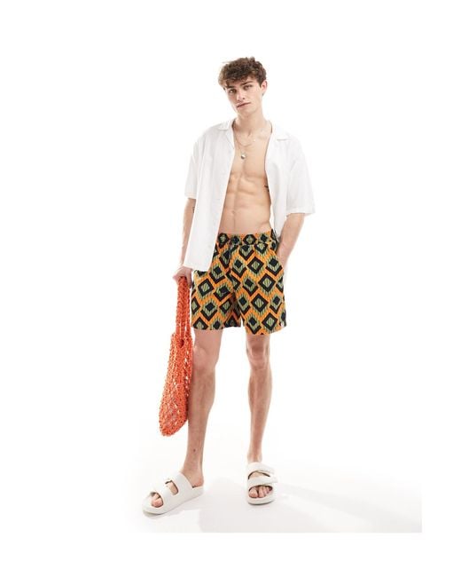 Pantaloncini da bagno con motivo geometrico a righe e arancione di Hunky Trunks in White da Uomo