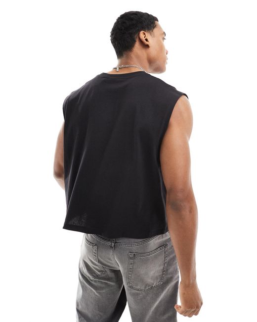 Camiseta corta negra extragrande sin mangas con estampado urbano ASOS de hombre de color Black