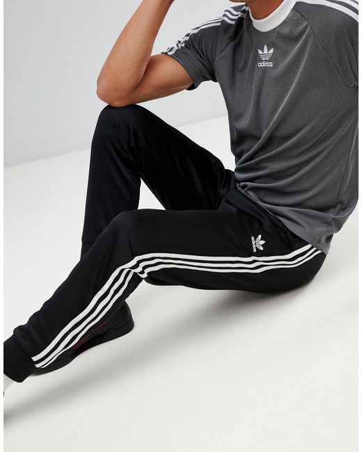 adidas originals superstar 3 stripe joggers in black