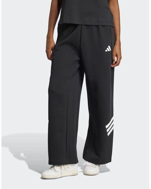 Pantalones Negros Con Bajo Amplio Y 3 Rayas Future Icons De Adidas Originals de color Black