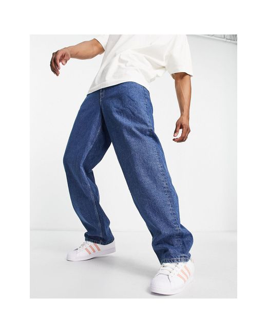 Jeans ultra ampi lavaggio medioASOS in Denim da Uomo colore Blu | Lyst