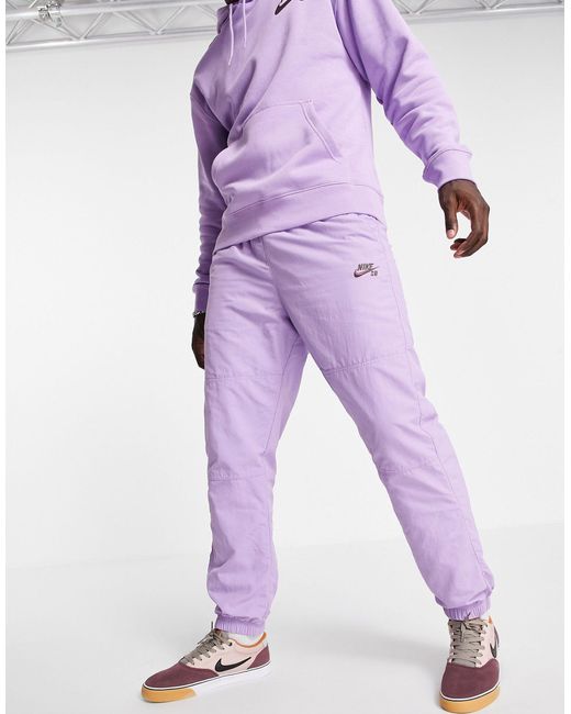 purple nike track pants