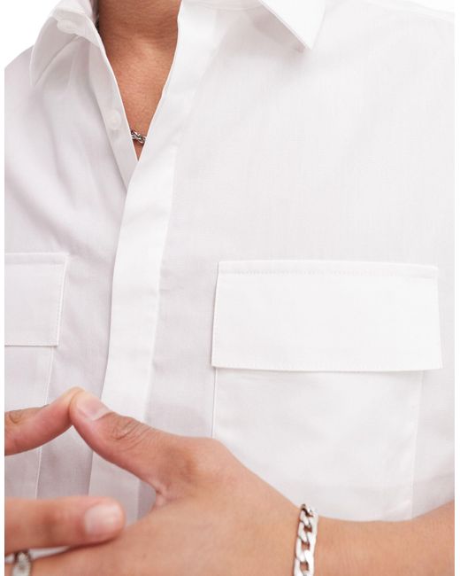 Camisa blanca sin mangas con bolsillos ASOS de hombre de color White