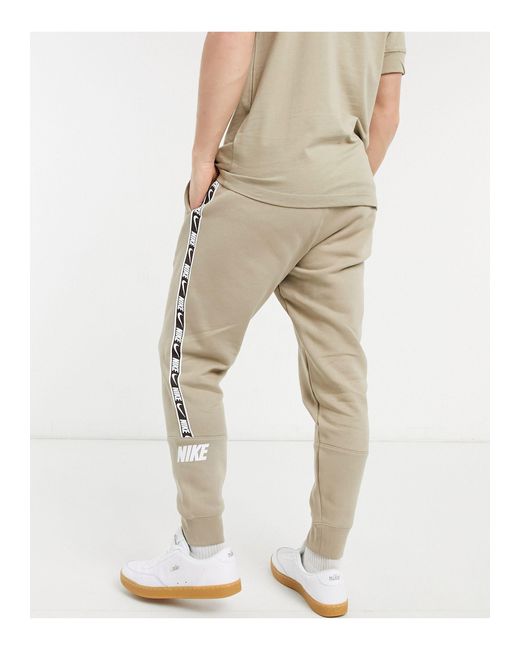 nike repeat pack logo taping cuffed joggers in khaki