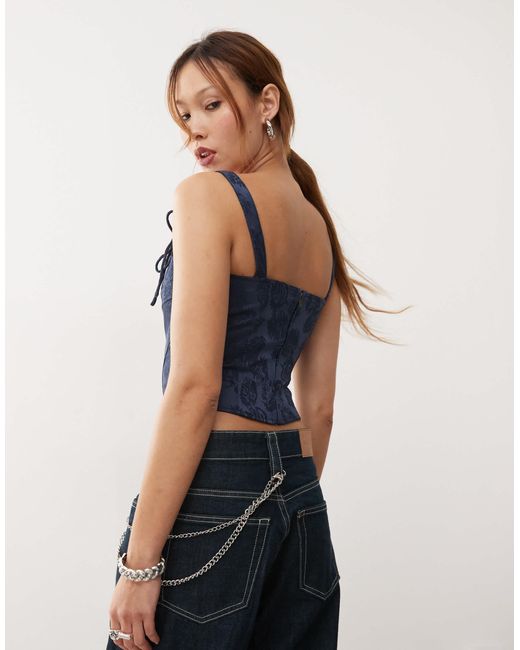 Top corset à bretelles fines et liens noués Lioness en coloris Blue