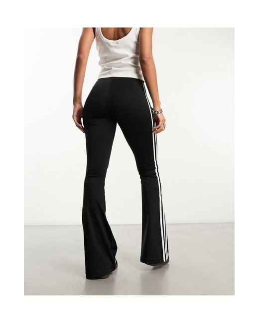 https://cdna.lystit.com/520/650/n/photos/asos/2cd9f762/adidas-originals-Black-Three-Stripe-Flared-leggings.jpeg