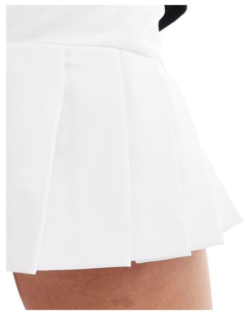 Ultimate - mini jupe-short plissée coupe ajustée Collusion en coloris White