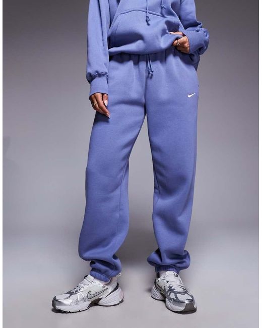 Joggers Azules Extragrandes De Talle Alto Con Bajos Ajustados Phoenix Fleece De Nike de color Blue