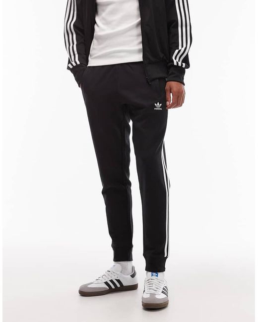 Adidas Originals Blue Three Stripe joggers for men