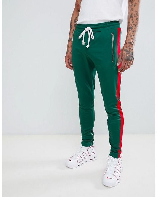 Criminal Damage Skinny Sweatpants In Green With Red Side Stripe for men