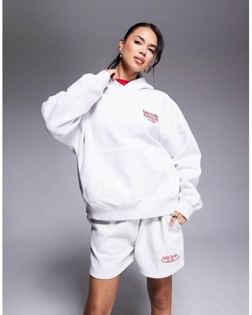 Sudadera Extragrande Con Capucha Y Estampado "Running Club" Studio De (Parte De Un Conjunto) Kaiia de color White