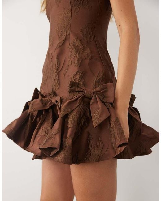 Sister Jane Natural Exclusive Jacquard Sleeveless Cinched Waist Bow Hem Mini Dress