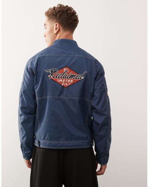 Reclaimed Vintage Blue Unisex Nylon Motor Jacket With Logo Badges And Embroidery