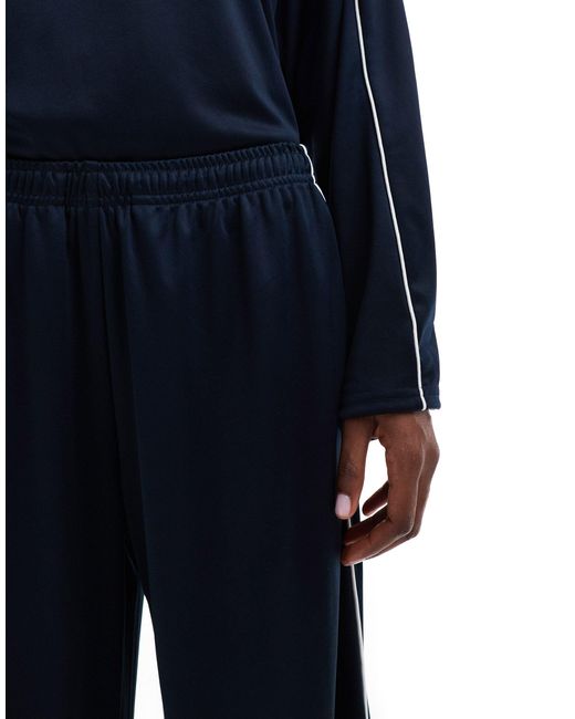 Weekday Blue – glänzende jersey-jogginghose