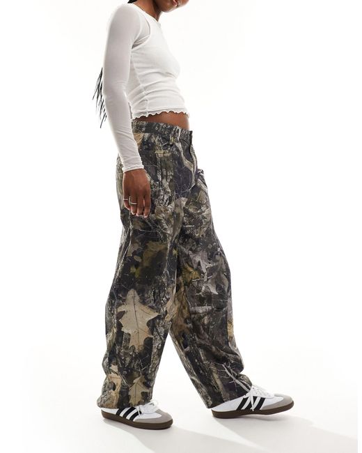 Pantalon large à imprimé camouflage Reclaimed (vintage) en coloris Black