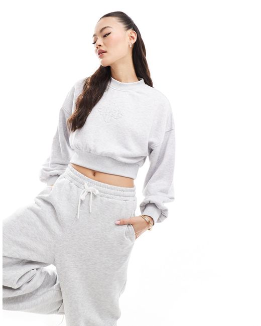 The Couture Club White Cropped Emblem Sweatshirt