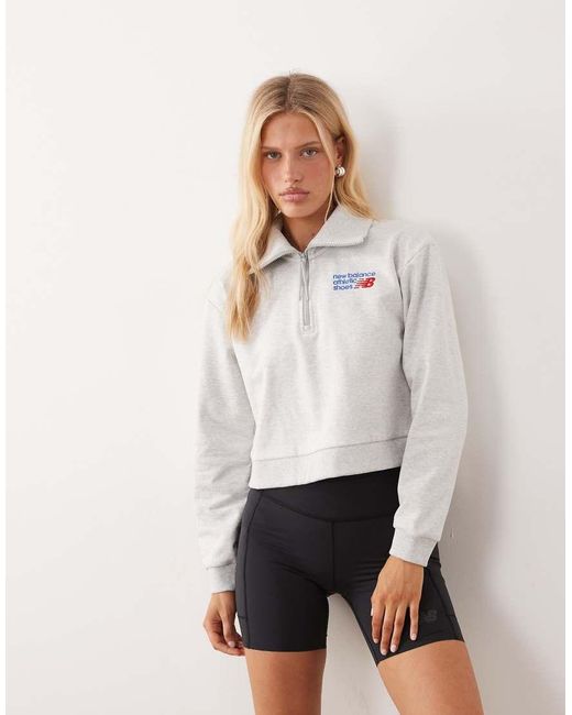 New Balance Natural Athletics Premium Logo Relaxed Fit Cropped Quarter Zip Top
